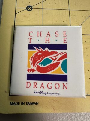 Walt Disney Imagineering employee button pin featuring a "Chase the Dragon" design