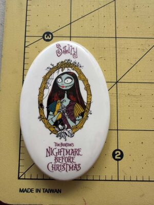 oval button features Sally from The Nightmare Before Christmas