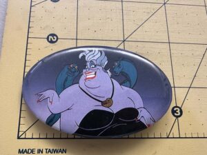 Oval button Ursula from The Little Mermaid flanked by her eels, Flotsam and Jetsam