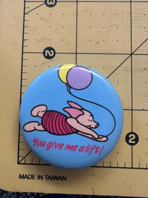 Disney Winnie the Pooh collectible button featuring Piglet flying with two balloons