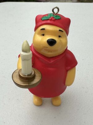 Disney Winnie the Pooh Christmas holiday ornament featuring Pooh holding a candle while wearing red pajamas