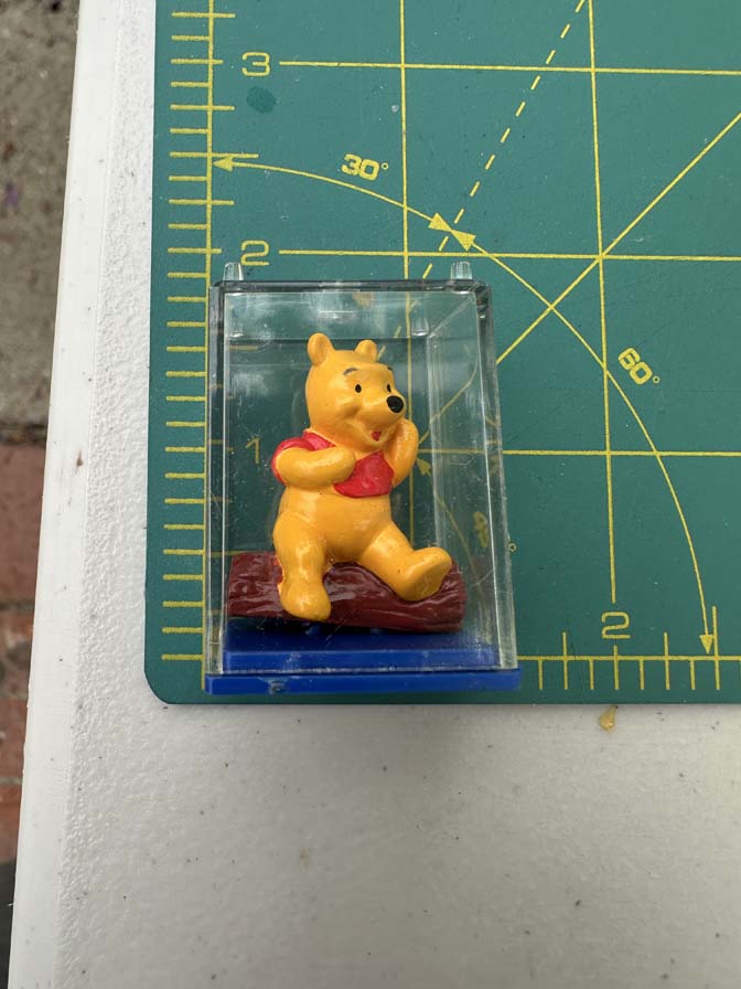 Winnie the Pooh collectible figure is encased in a clear plastic display box with a blue base - Image 6