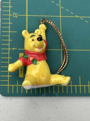 vintage Disney Winnie the Pooh ornament is crafted from bone china and features the bear wearing a red scarf
