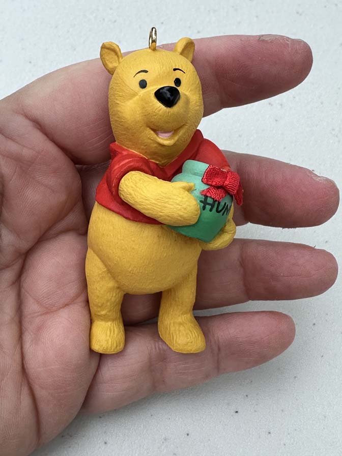 1991 Hallmark Keepsake ornament featuring Winnie the Pooh holding a green "Hunny" pot