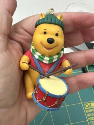 vintage Grolier Disney Christmas Magic ornament featuring Winnie the Pooh playing a drum.