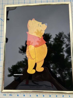 1980s Kafka Industries foil art print features Winnie the Pooh against a black background in a gold-tone frame