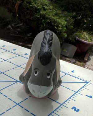 Eeyore sitting on pink pedestal PVC