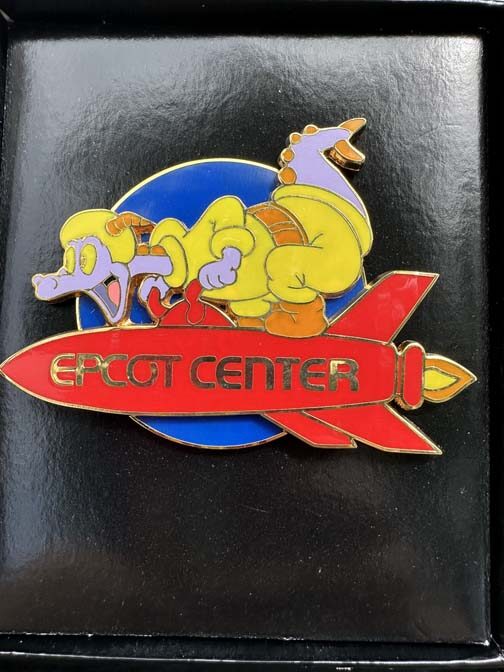 Disney jumbo pin features Figment riding a red Epcot Center rocket