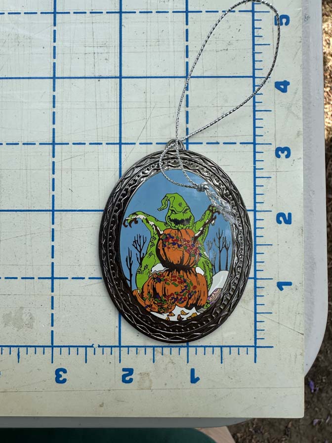 Nightmare Before Christmas themed gift set features items tucked into a black, coffin-shaped display box Oogie with Snowman Pin - Image 6