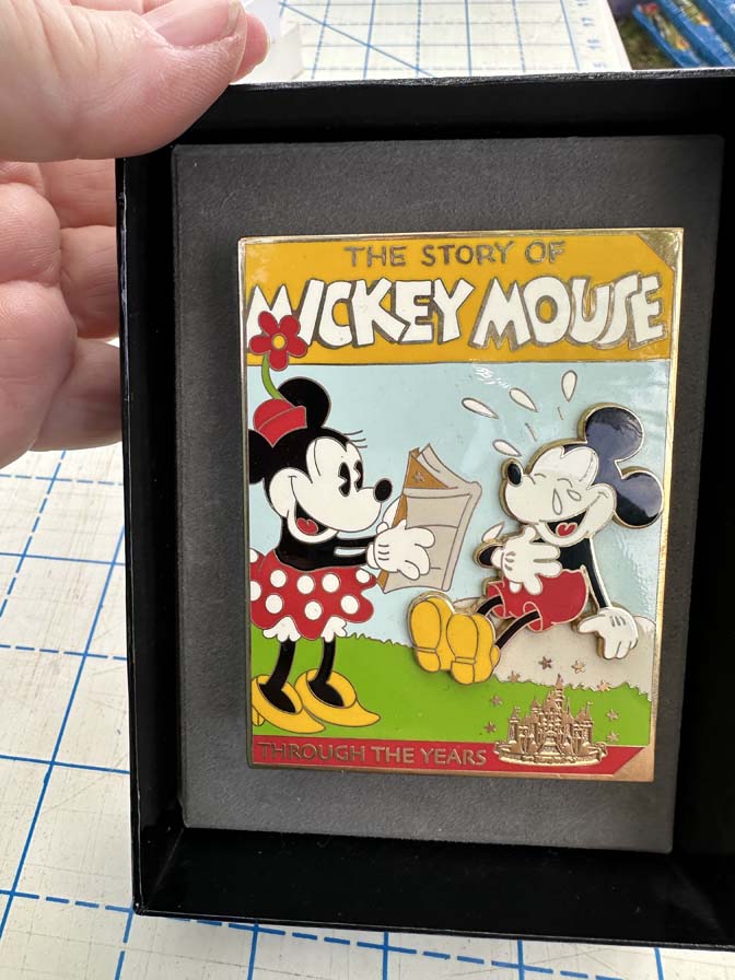 Jumbo pin "The Story of Mickey Mouse Through the Years," featuring Mickey and Minnie Mouse in a classic animation style