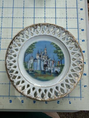 Vintage Disneyland souvenir plate featuring Sleeping Beauty Castle with lace edge