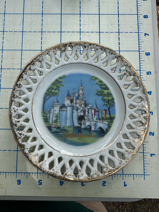 Vintage Disneyland souvenir plate featuring Sleeping Beauty Castle with lace edge