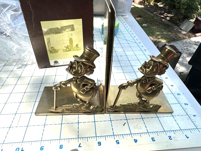 vintage Walt Disney Productions Scrooge McDuck bookends are crafted from solid brass