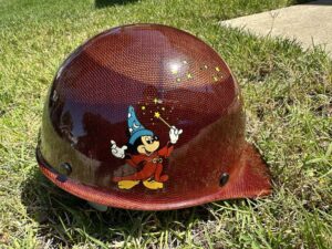 Walt Disney Imagineering (WDI) hard hat, JOE name specifically featuring a red carbon-fiber style finish and Sorcerer Mickey Mouse.