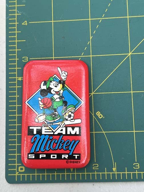 vintage Disney Team Mickey Sport button featuring Mickey Mouse surrounded by various sports equipment