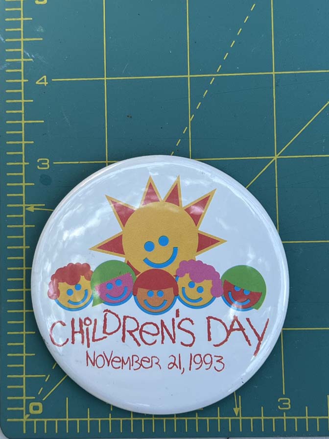 Walt Disney World Children's Day button from November 21 1993 features a colorful sun and children graphic